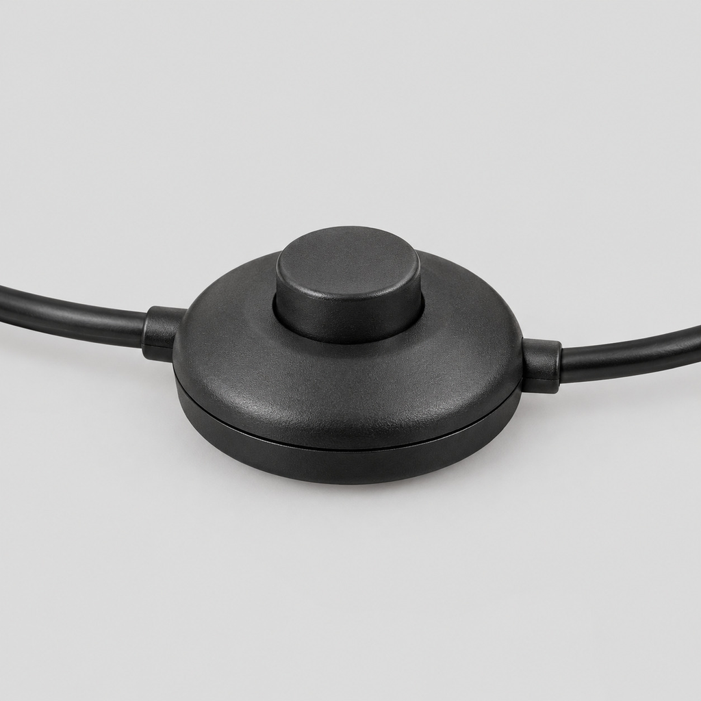 Close up of the foot switch on the cord of the Matte Black arched floor lamp.
