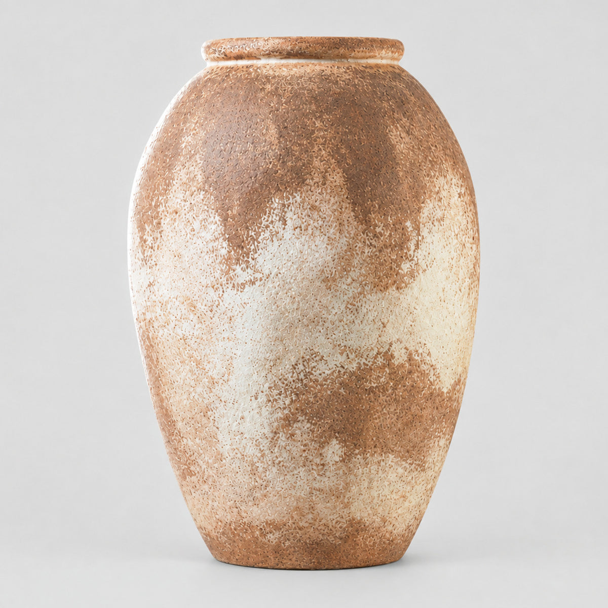 Textured ceramic vase in Weathered Terracotta on a light gray studio background, in its Round Vase shape