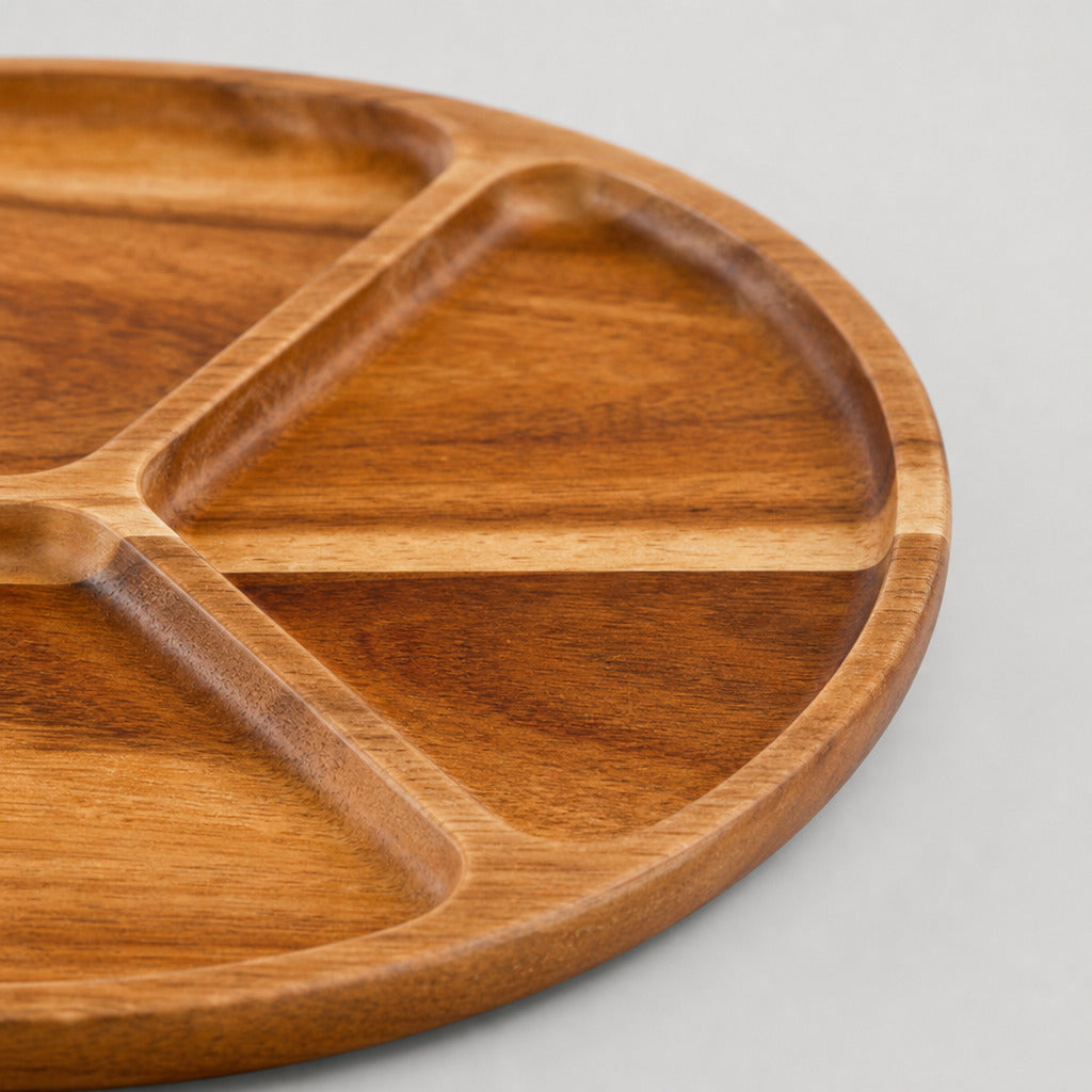 Close up of the smooth curved rim of the three-compartment round wooden serving tray
