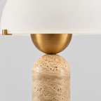 Close up of the rim where the glass shade meets the brass fitter on the travertine dome table lamp