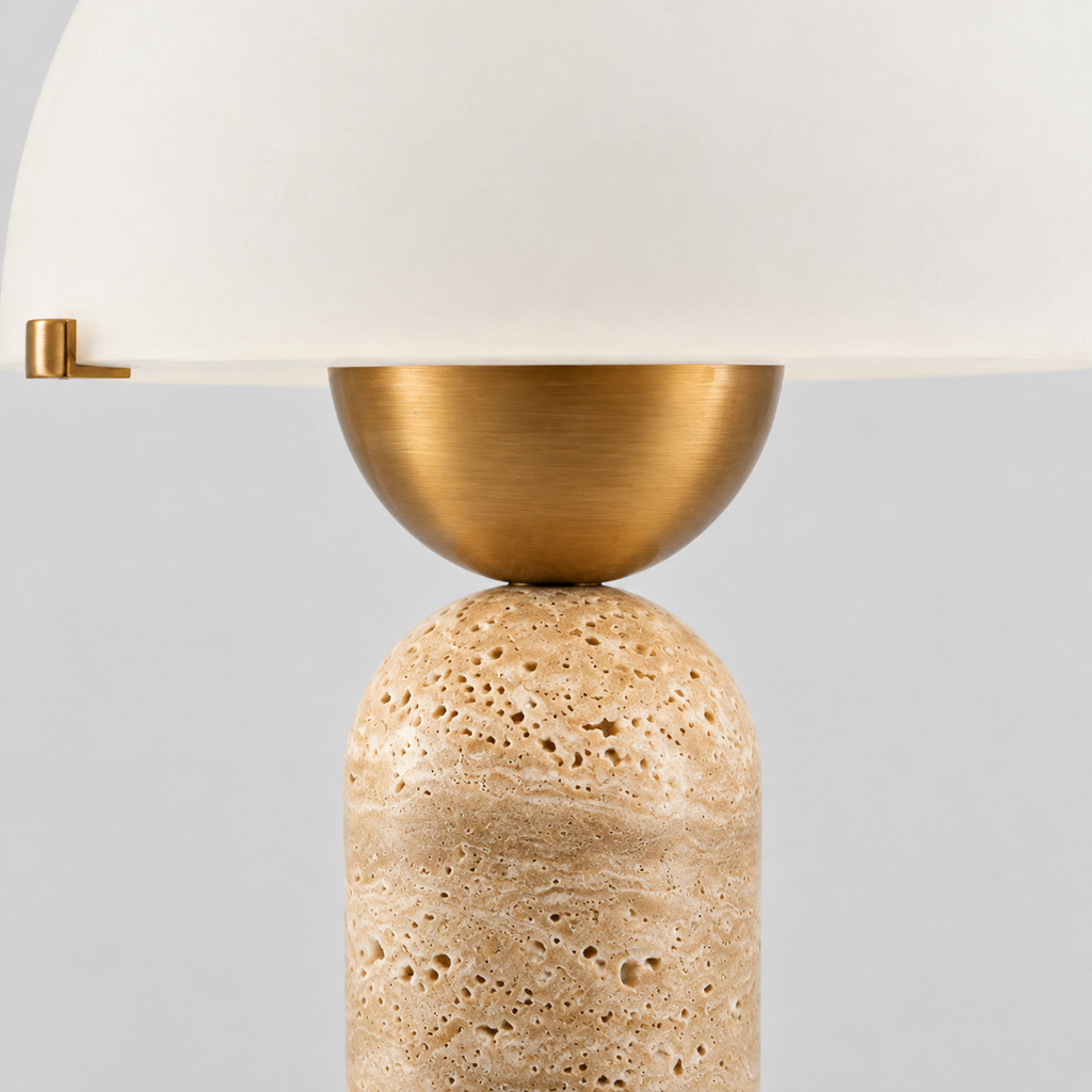 Close up of the rim where the glass shade meets the brass fitter on the travertine dome table lamp