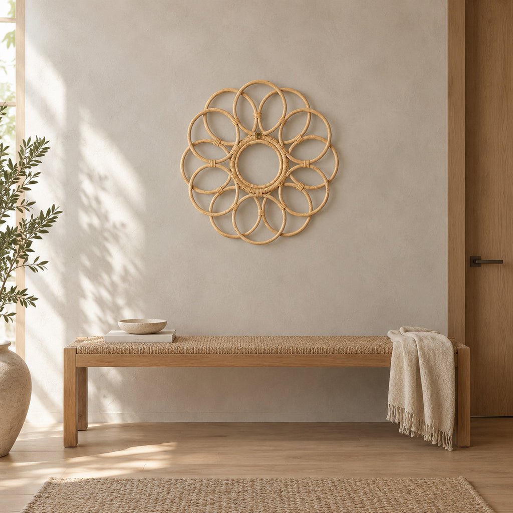 Decorative looped rattan wall frame in Natural Rattan mounted on a greige plaster wall above a 120 cm wide low bench in a calm room.