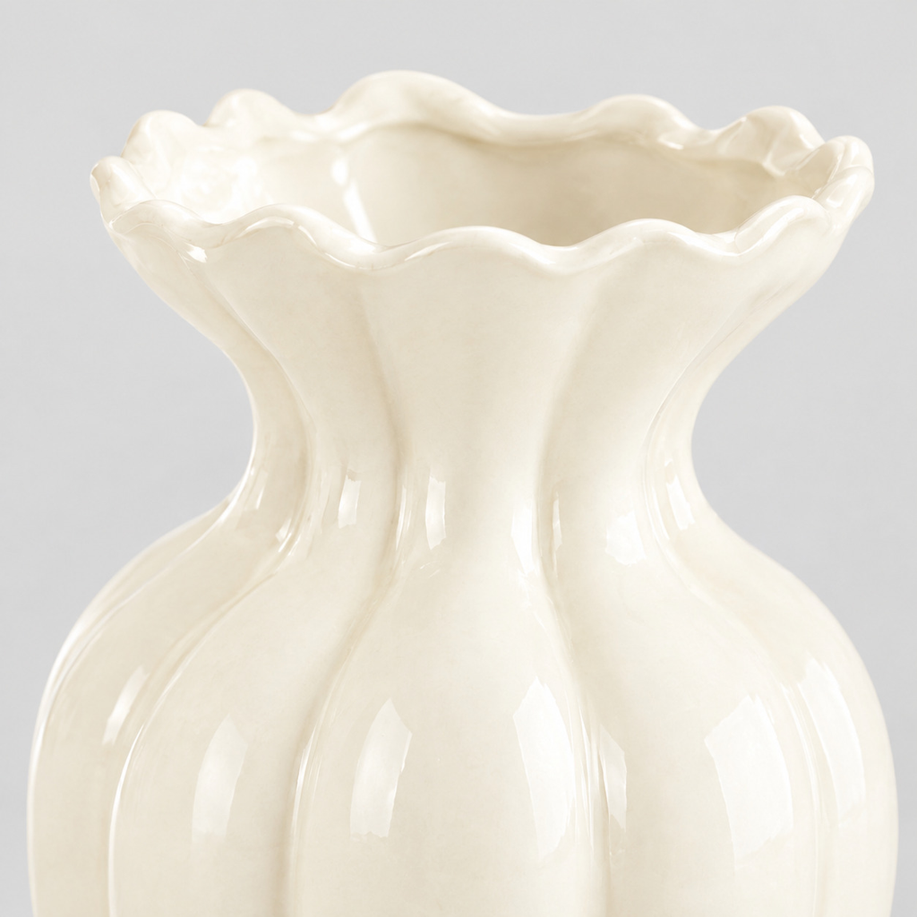 Close up of the fluted ceramic body with glossy cream glaze of the ceramic vase.