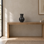 Black textured ceramic vase on a 120 cm wide oak console table in a calm room.
