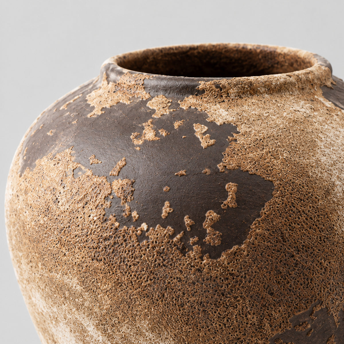 Close up of the textured earthy glaze across the ceramic body of the weathered ceramic vase in Weathered Brown.