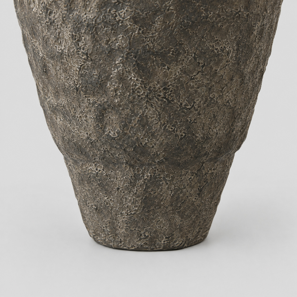 Close up of the tapered base of the textured ceramic urn vase in Charcoal finish