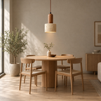 Travertine pendant light lit hanging above a round oak dining table against a plain wall