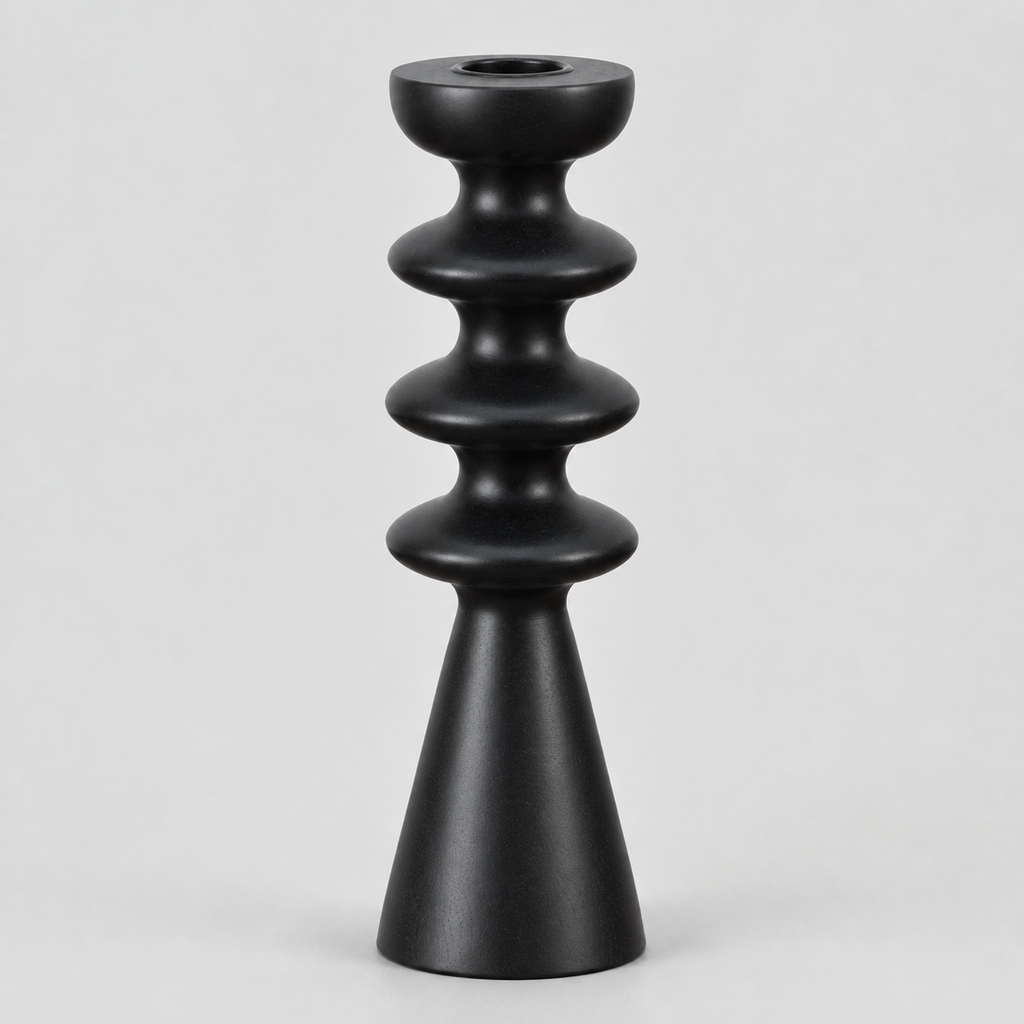 Matte black turned beechwood taper candlestick on a light gray studio background