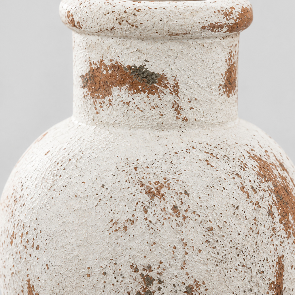Close up of the distressed weathered glaze across the rounded body of the rustic wabi-sabi ceramic vase.