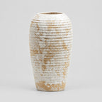 Ribbed barrel ceramic vase in Distressed White on a light neutral gray studio background.