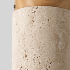 Close up of the pitted texture of the travertine shade of the cylindrical travertine ceiling light.