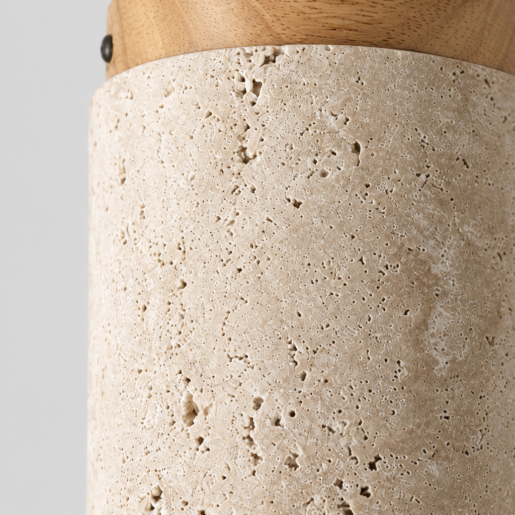 Close up of the pitted texture of the travertine shade of the cylindrical travertine ceiling light.
