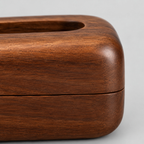 Close up of the horizontal seam where the top lid meets the base of the curved wooden tissue box.