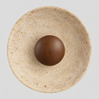 Round travertine disc wall sconce in Walnut finish on a light gray studio background