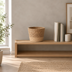 Natural Seagrass woven seagrass planter basket on an open oak shelf beside a few books in a calm room.