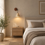 Conical travertine wall sconce in Travertine lit beside a double bed against a plaster wall