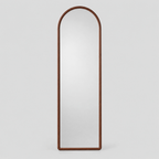 Arched solid wood full-length mirror in Walnut finish on a light gray studio background.