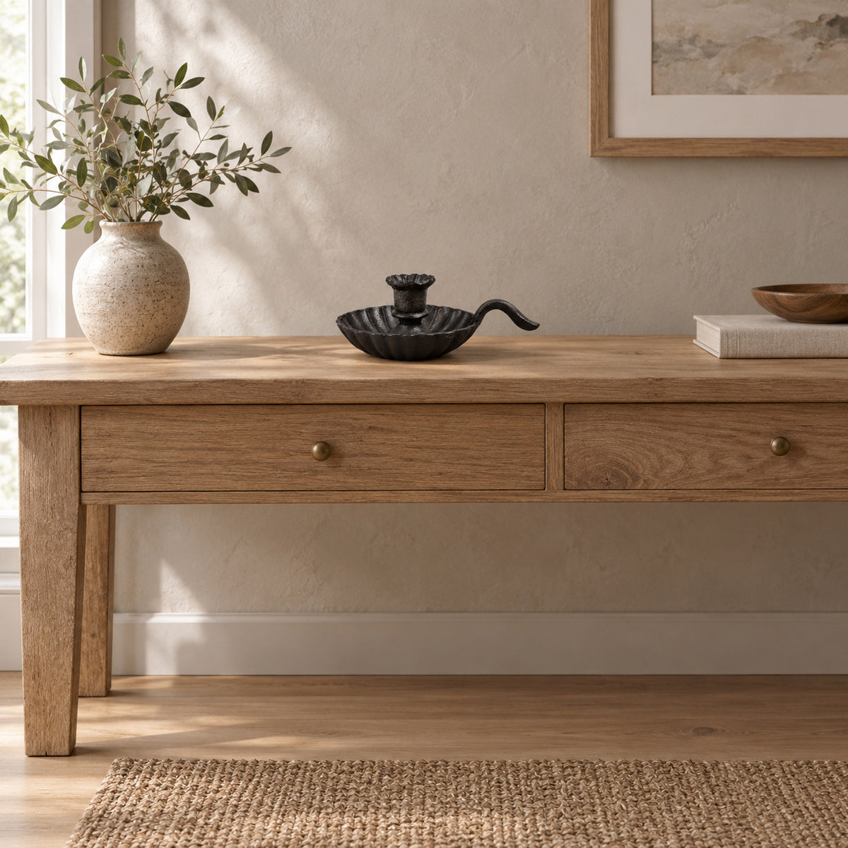 Cast iron chamberstick candle holder in Cast Iron on an oak console table in a calm room.
