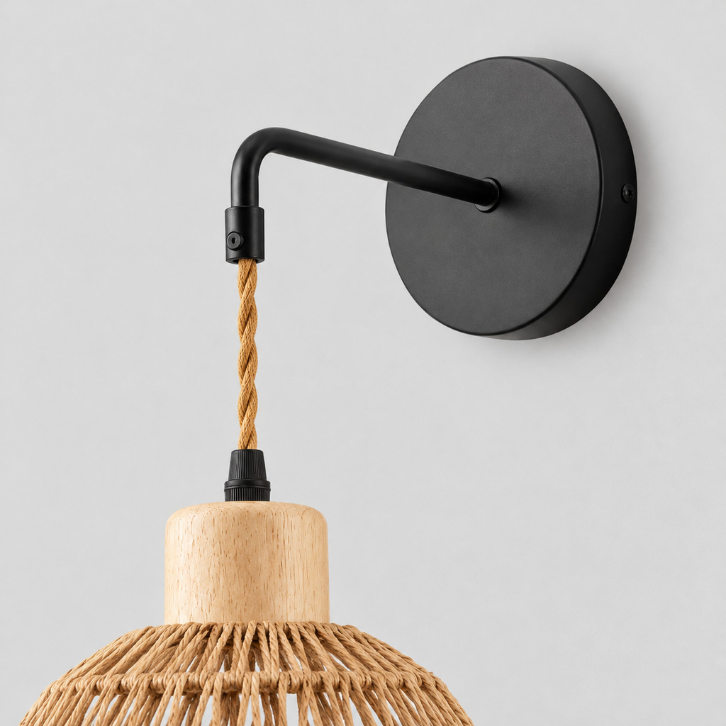 Close up of the round canopy against the wall of the Natural Rope woven dome wall sconce
