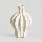 Coarse ceramic fluted vase in Speckled White on a light gray studio background.