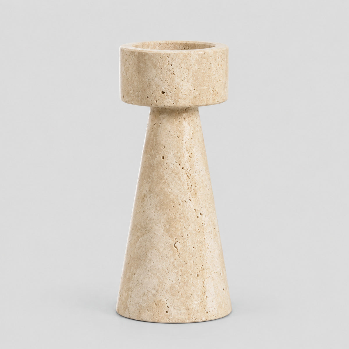 Travertine stone candle holder in Beige Travertine on a light gray studio background
