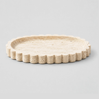 Scalloped oval travertine tray in Natural Travertine on a light gray studio background