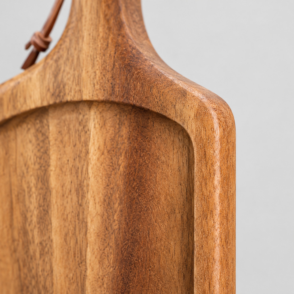 Close up of the raised outer rim of the acacia wood handled serving board.