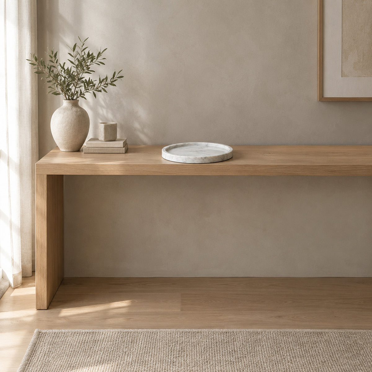 Round marble tray on a 120 cm wide oak console table in a calm room.