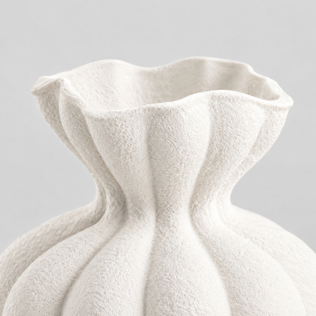 Close up of the pinched ruffled rim of the textured matte white ceramic vase in Matte White.