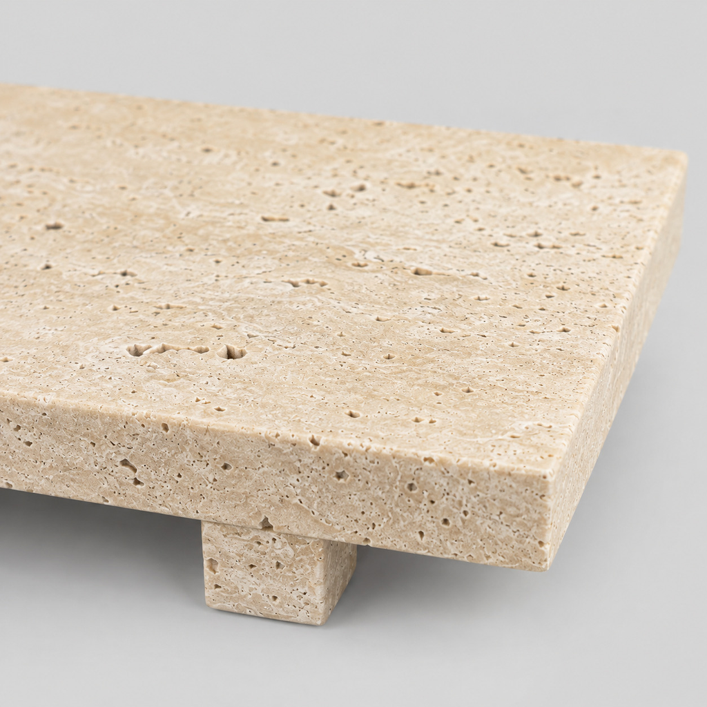 Close up of the porous surface texture of the beige travertine tray