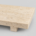 Close up of the porous surface texture of the beige travertine tray