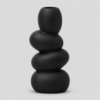 Black stacked pebble ceramic vase on a light gray studio background.