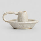 Ceramic taper candle holder in Speckled Off-White on a light gray studio background