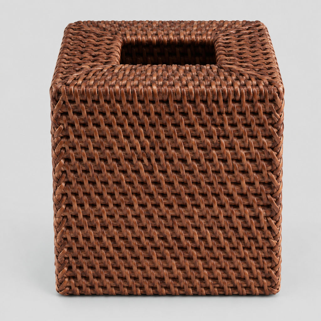 Brown rattan cube tissue box cover on a light gray studio background.
