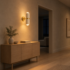 Dual-light ceramic wall sconce lit in the evening on a hallway plaster wall beside an 80 cm wide doorway, the only light in the room
