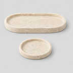 Round beige travertine catchall tray in Beige Travertine on a light gray studio background.