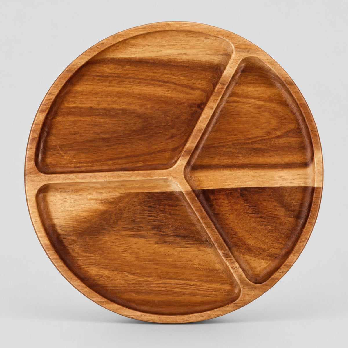Three-compartment round wooden serving tray in Acacia Wood on a light gray studio background