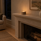 Natural bark stump candle holder on a 140 cm wide mantelpiece above a fireplace with one lit tealight candle in the holder.