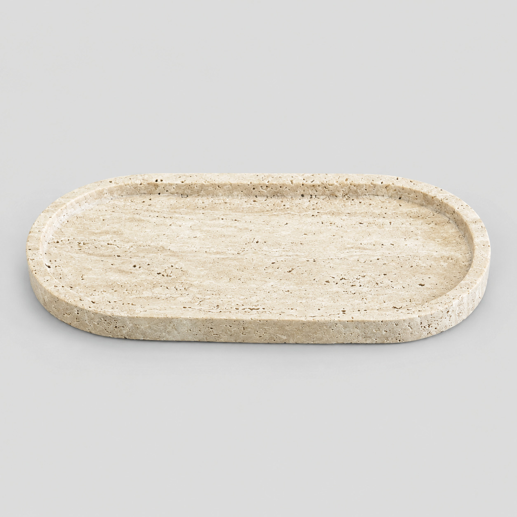 Oval stone vanity tray in Beige Travertine on a light gray studio background