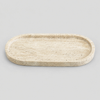 Oval stone vanity tray in Beige Travertine on a light gray studio background