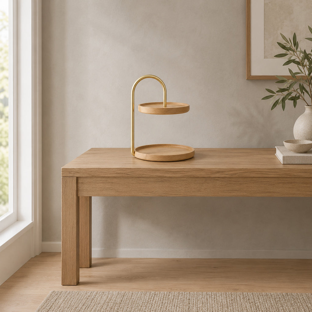 Two-tier round wooden serving tray in Beech on an oak console table in a calm room.