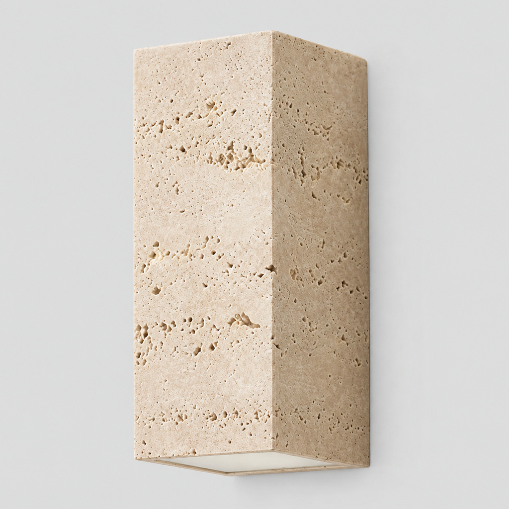 Travertine block wall sconce in travertine on a light gray studio background
