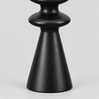 Close up of the smooth conical base of the matte black turned beechwood taper candlestick