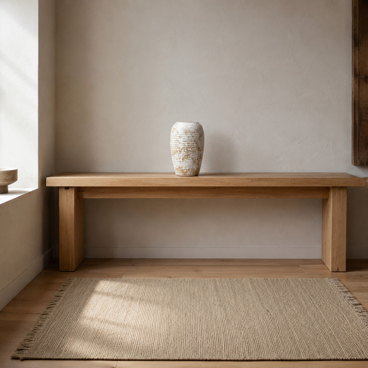 Ribbed barrel ceramic vase in Distressed White on a 120 cm wide oak console table in a calm room.