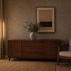 Weathered ceramic vase in Weathered Brown on a walnut sideboard with a bunch of eucalyptus in the vase.