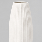 Close up of the vertical ribbed texture of the matte white ceramic vase