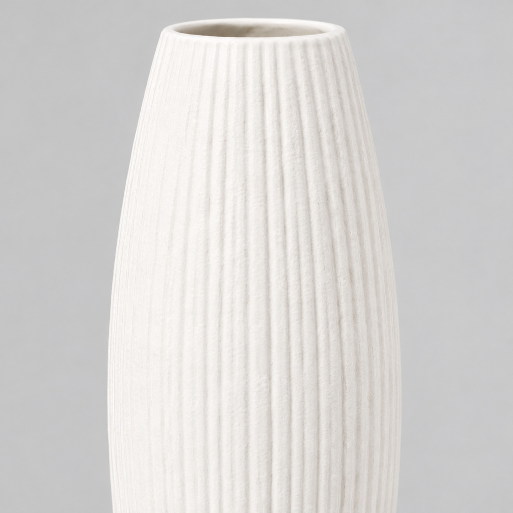 Close up of the vertical ribbed texture of the matte white ceramic vase
