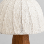 Close up of the weave or fabric texture of the shade of the walnut mushroom table lamp