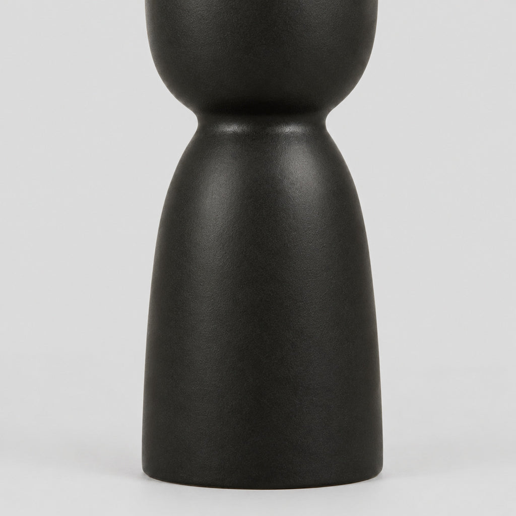 Close up of the pedestal base of the matte ceramic taper candle holder.