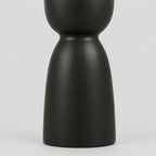 Close up of the pedestal base of the matte ceramic taper candle holder.